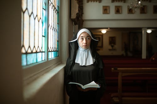 Free A Nun Holding a Bible Stock Photo