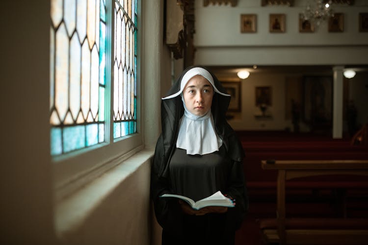 A Nun Holding A Bible