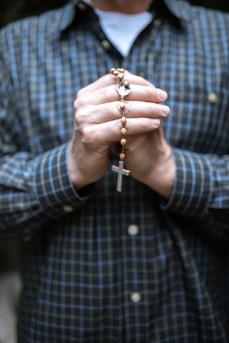 Person In Blue And White Plaid Dress Shirt Holding Gold Ring