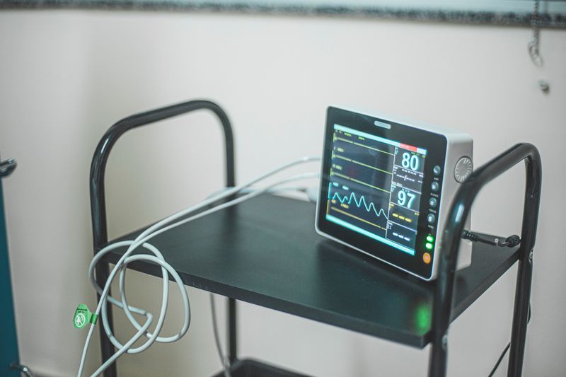 Medical equipment showing heart rate on screen in hospital room