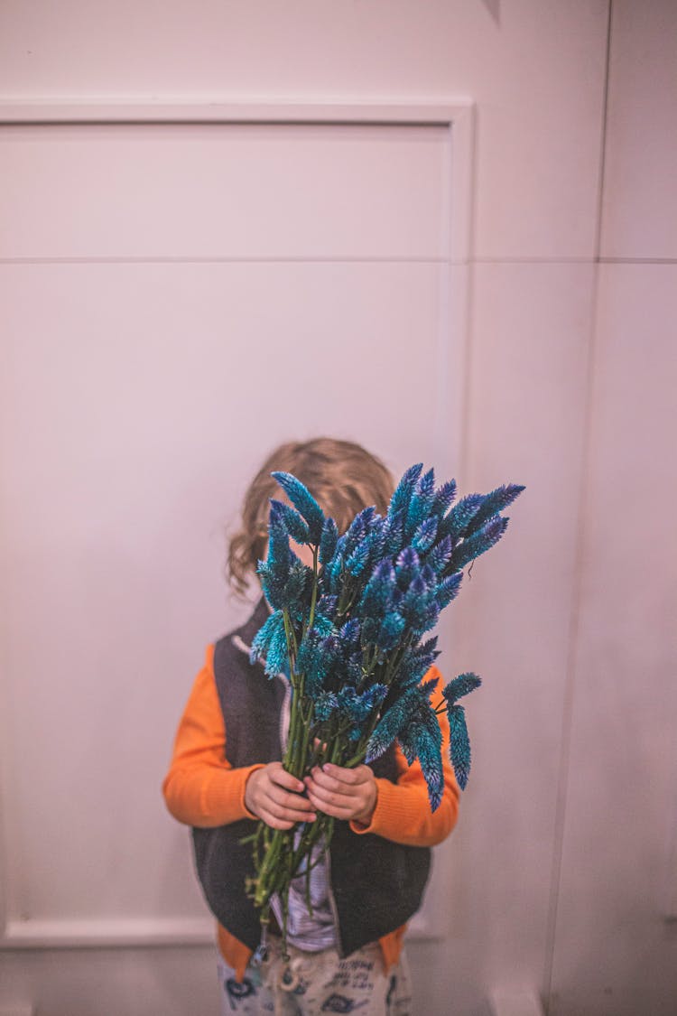 Child Holding A Bunch Of Bunny Tails