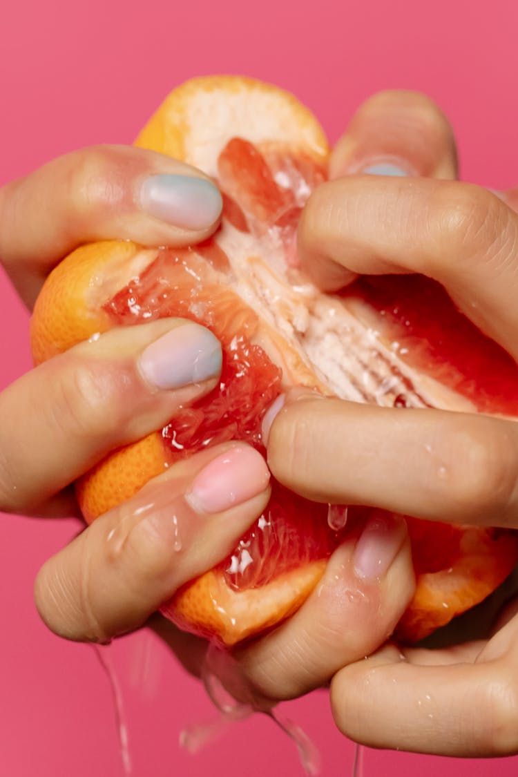 Person Squeezing An Grapefruit 