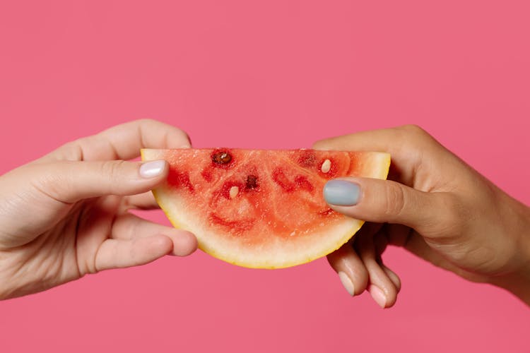 Person Holding Sliced Of Watermelon