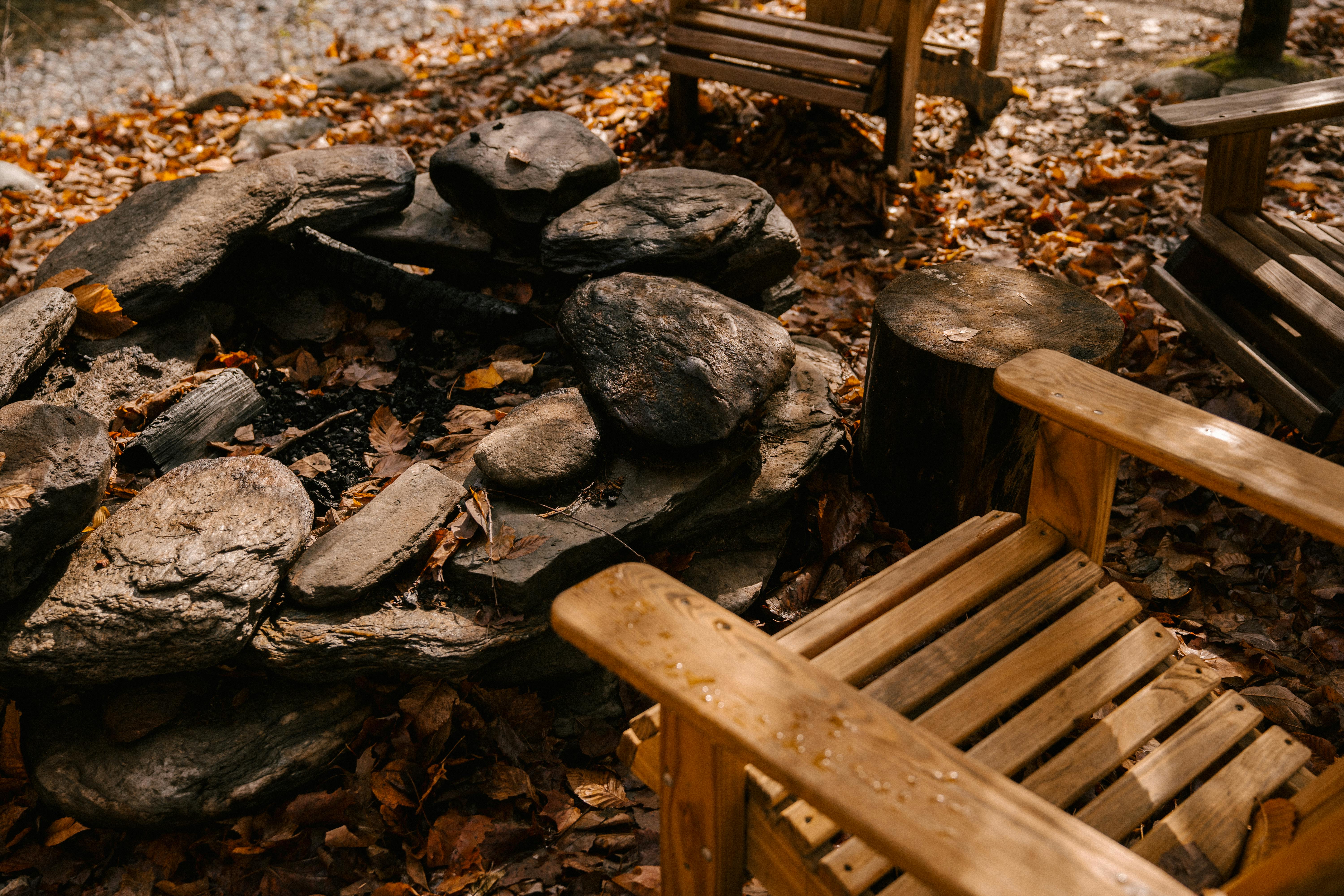 Wooden chairs near place for fire · Free Stock Photo