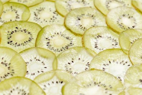 Close-Up Shot of Slices of Kiwi on a White Surface