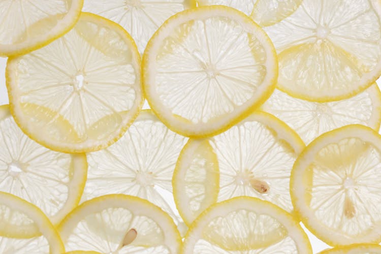 Close-Up Shot Of Slices Of Lemons On A White Surface