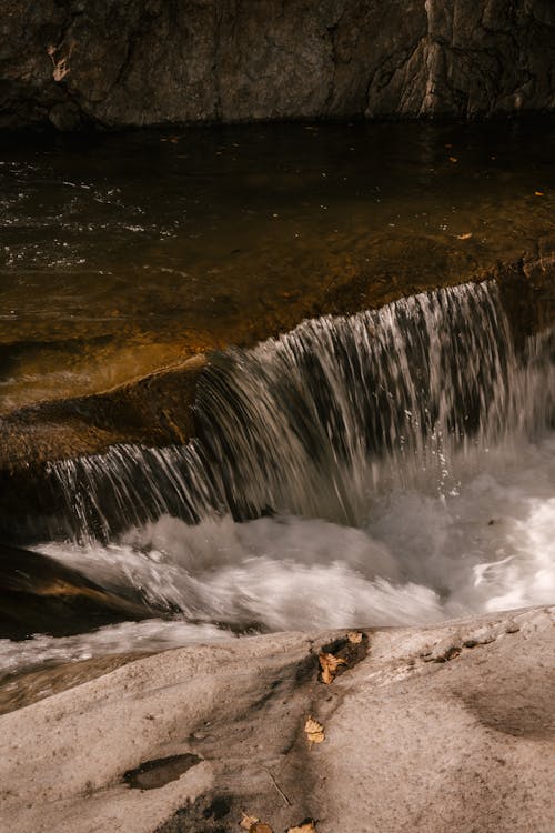 Waterfall flowing from rocky cliff