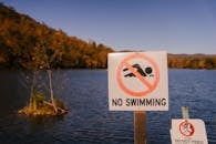 Forbidden sign near sea in countryside