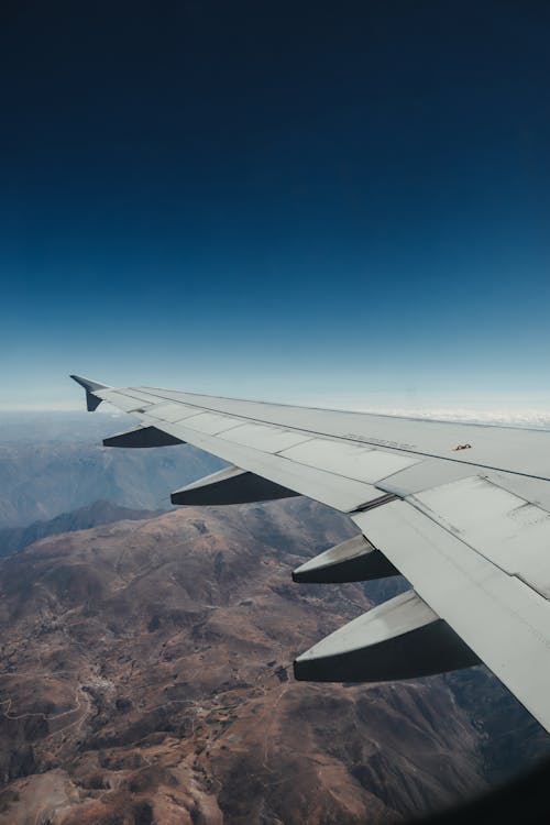 Airplane Wing above Mountains