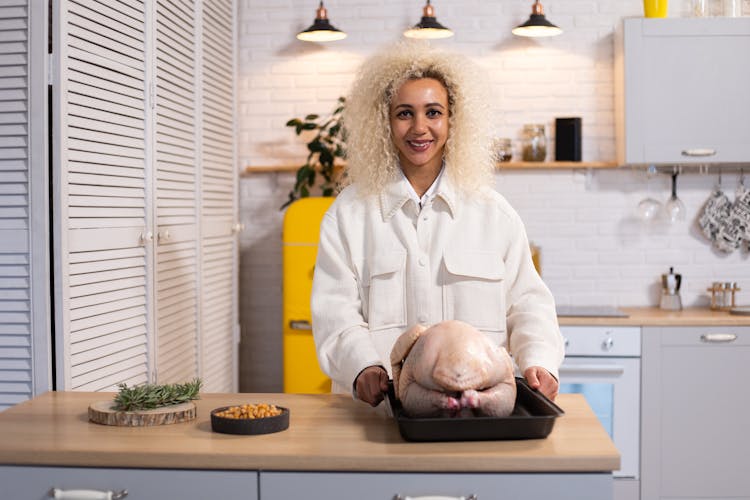 Cheerful Woman With Raw Turkey