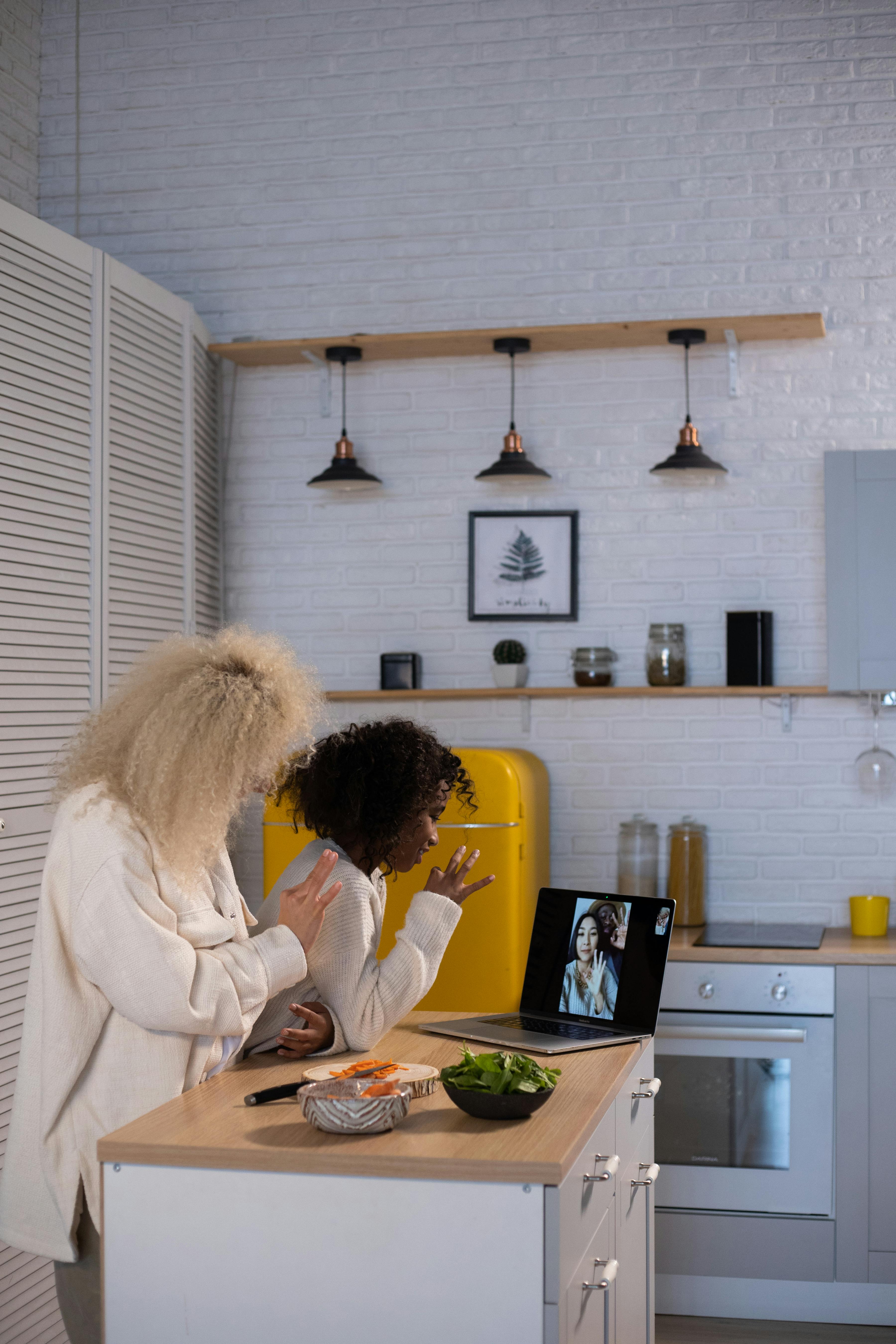 women waving on a video call