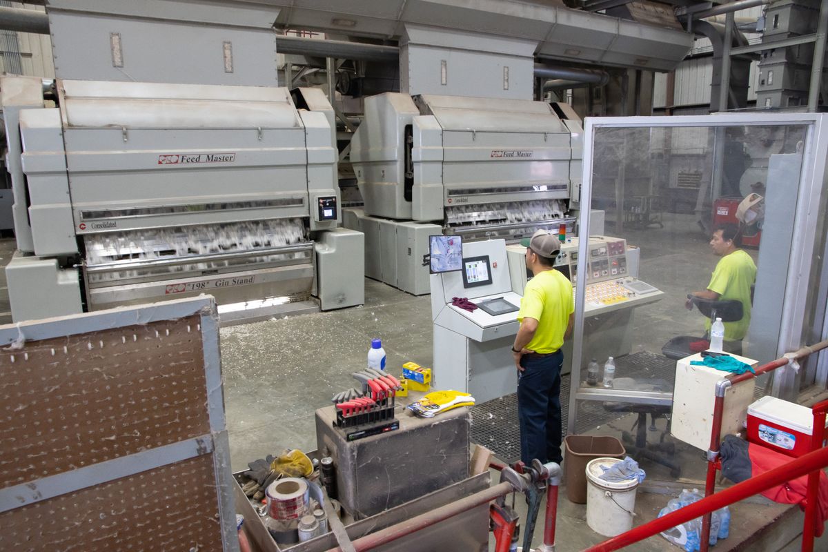 Workers operating machinery in a cotton ginning factory, representing Bathinda's cotton belt economy