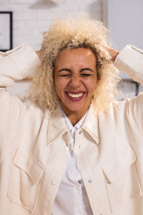 Excited black woman rumpling hair