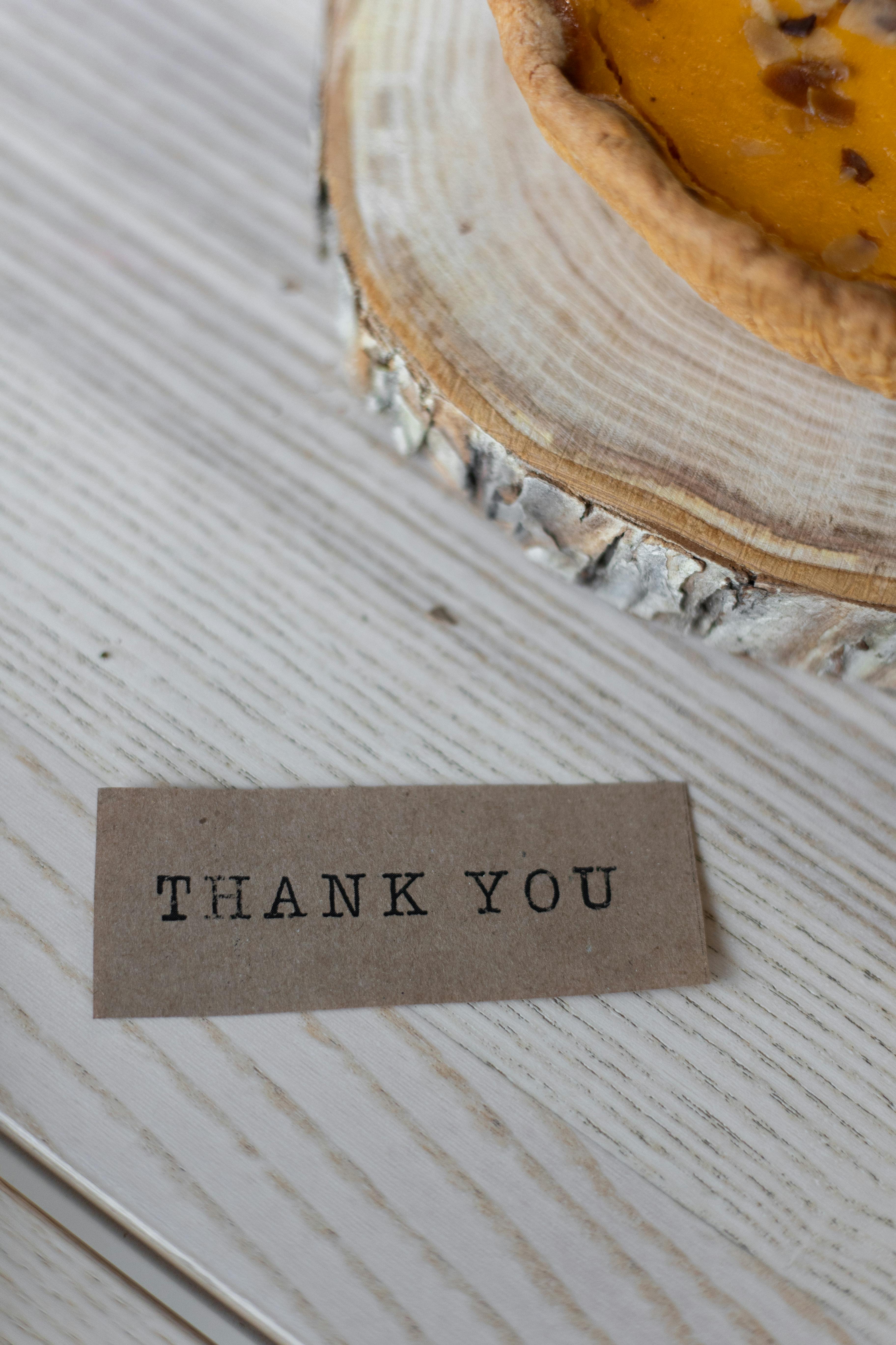paper with thank you inscription on table