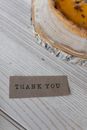 Paper with Thank You inscription on table