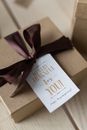 From above of gift in carton box with bow and postcard for Thanksgiving