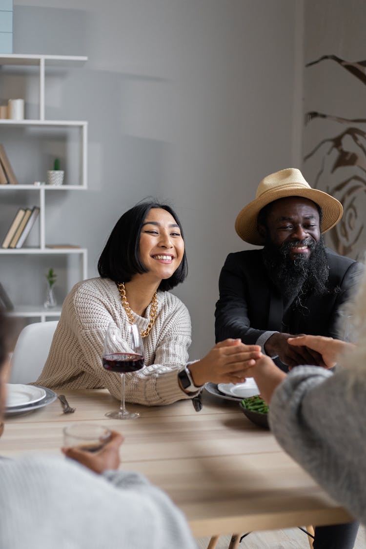 Cheerful Diverse Couple Having Dinner With Guests