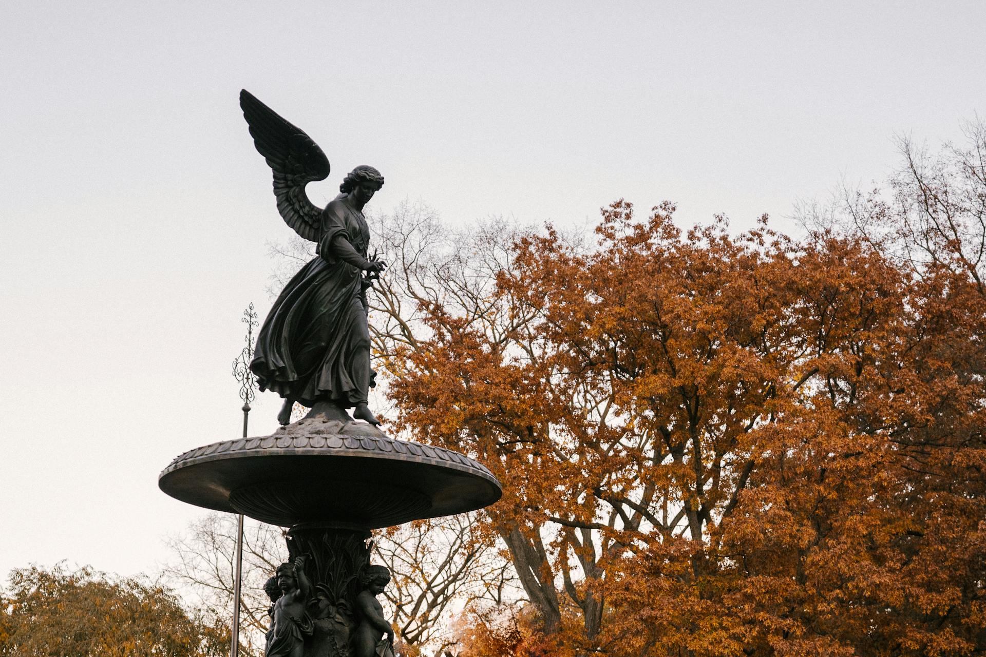 From below of famous Angel of the Waters statue of Bethesda Fountain placed in Central Park in New York City in autumn time