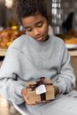 Calm black girl with gift box