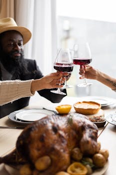 A joyful get-together with friends toasting over a holiday meal featuring a delicious roasted turkey.