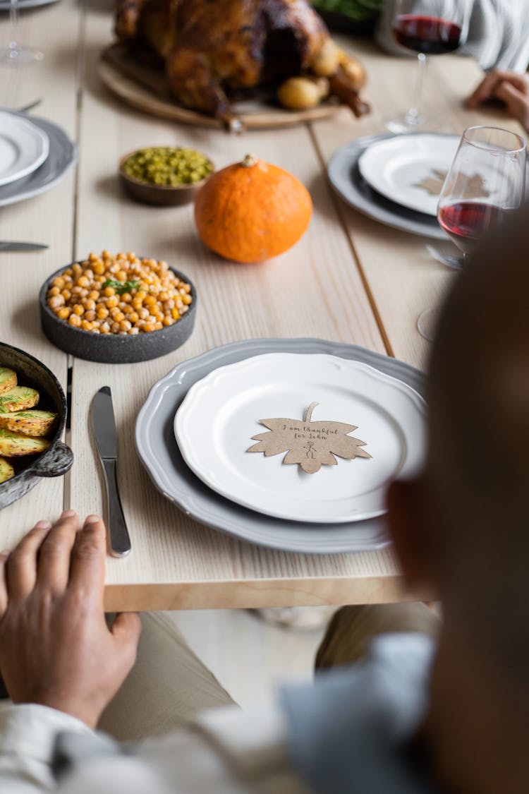 Crop Person At Table Served For Thanksgiving Dinner