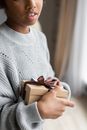 Crop black girl with gift box