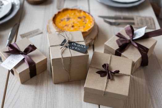 Gift boxes on table near pie