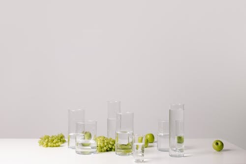 Clear Drinking Glasses Beside Green Fruits