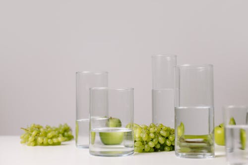 Grapes and Apples among Glasses of Water