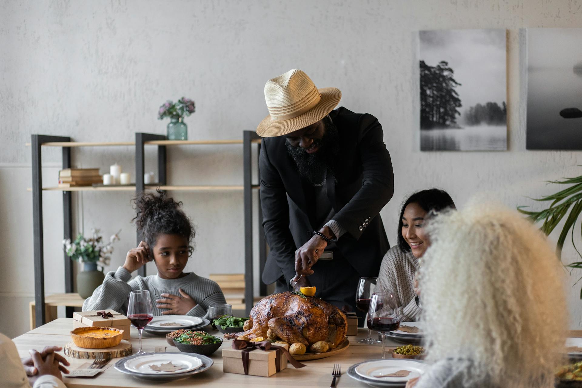 Cheerful diverse friends celebrating Thanksgiving Day with turkey