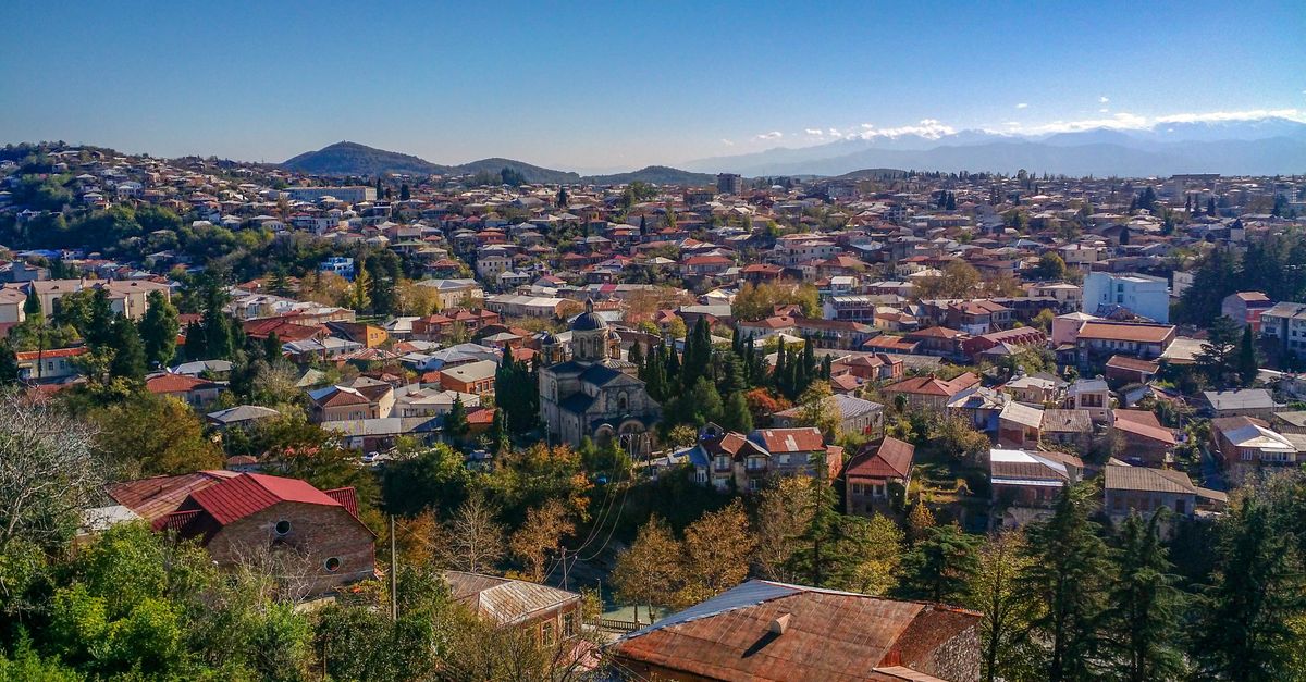 Explore the stunning aerial view of Kutaisi, Georgia, showcasing vibrant architecture and lush greenery.