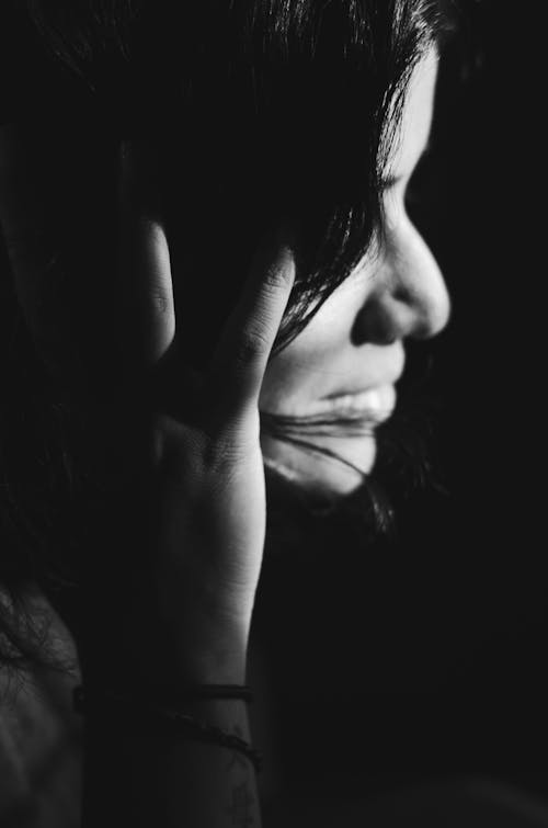 Free Grayscale Photo of a Woman Touching Her Hair Stock Photo