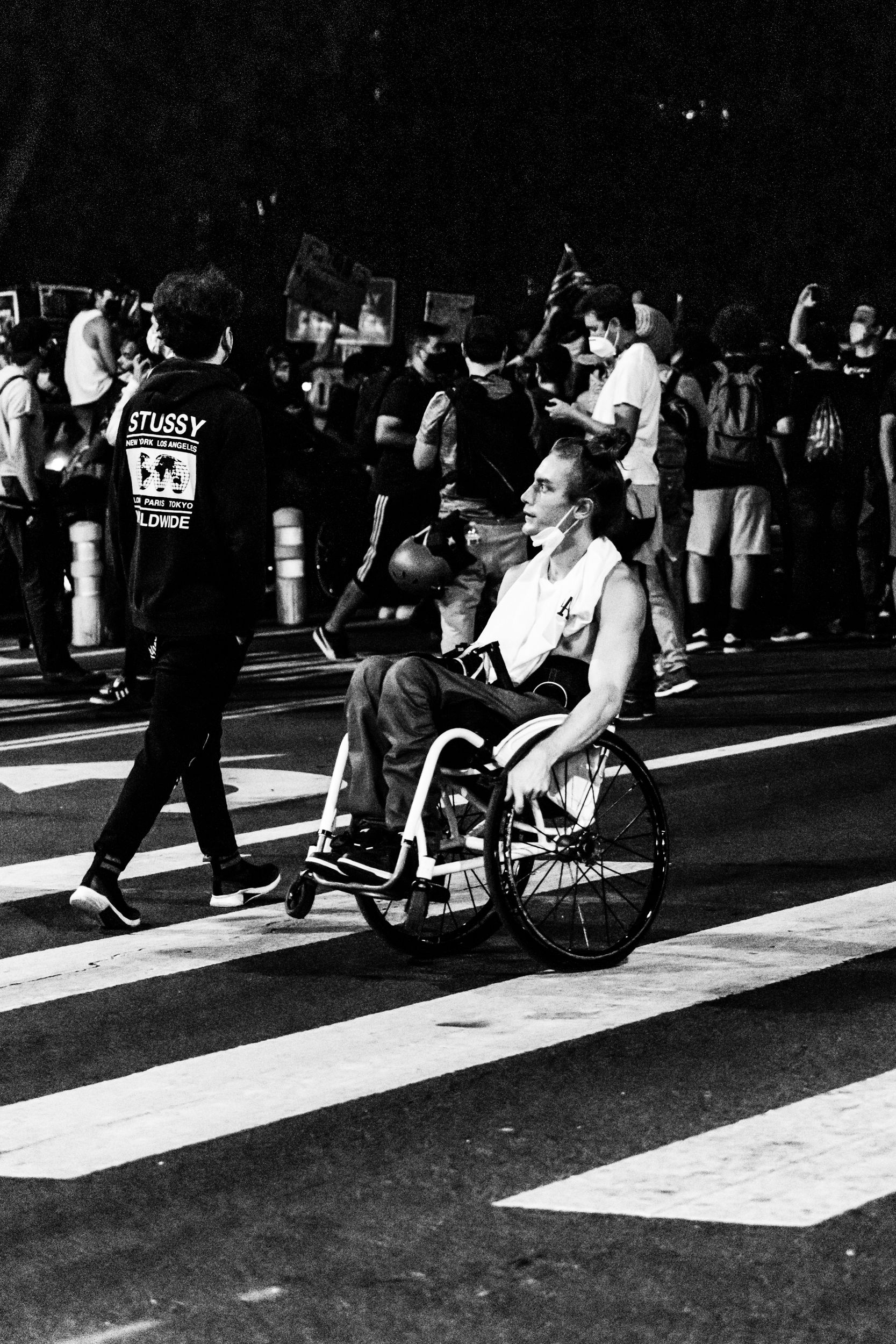 A Grayscale Photo of Man on a Wheelchair on the Street · Free Stock Photo