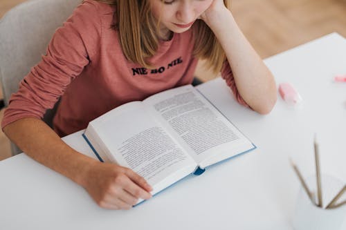 Woman in Pink Top Reading a Book