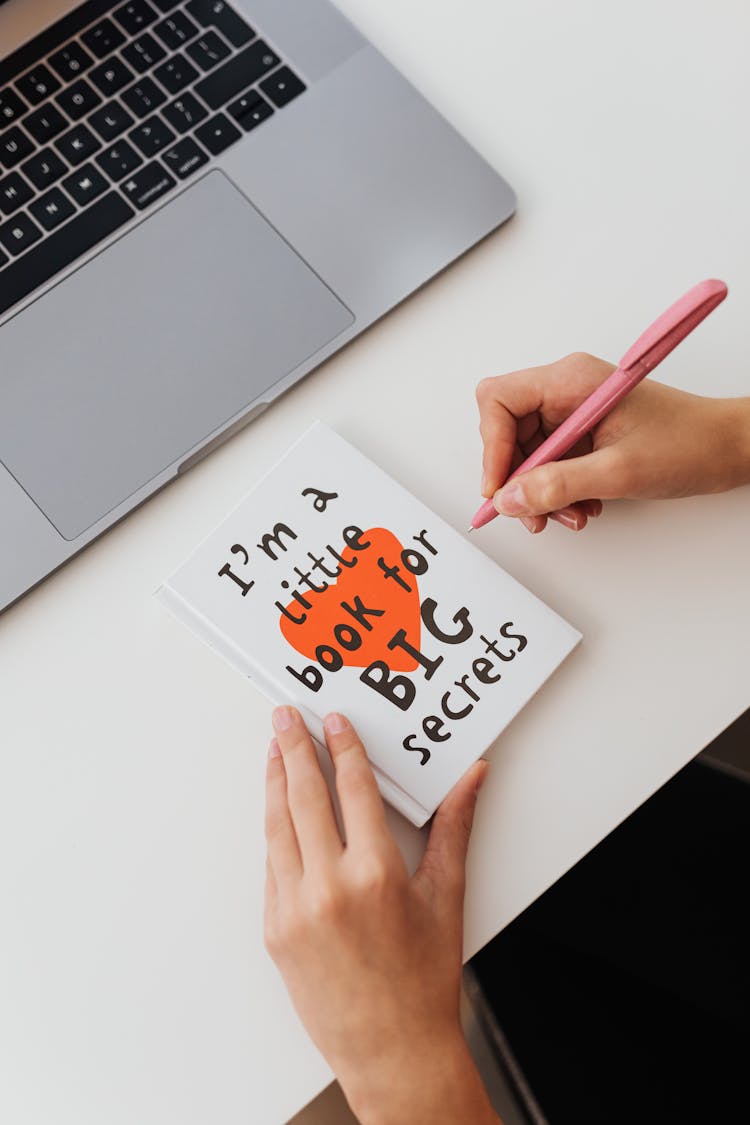 Unrecognizable Person Holding Greeting Card And Ball Pen