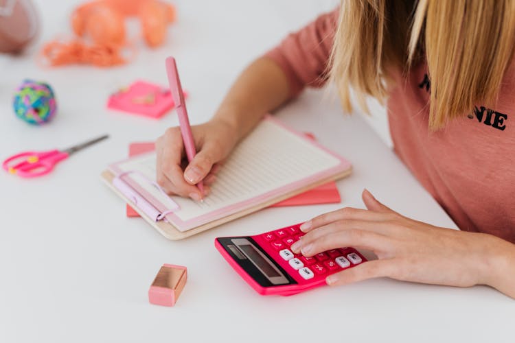 Girl Solving An Equation And Using A Calculator 