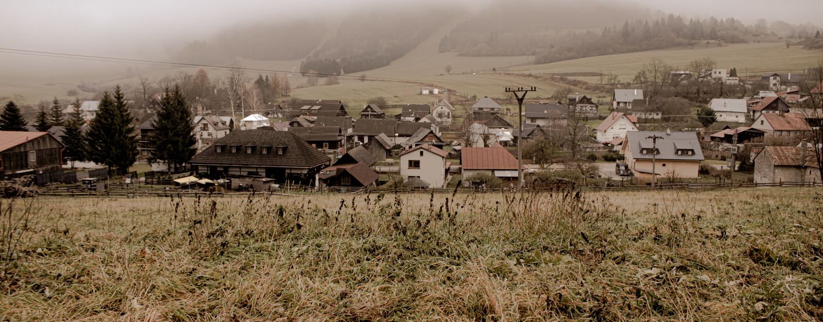 Scenic view of the foggy countryside village in Čičmany, Slovakia. Traditional rural landscape in fall.