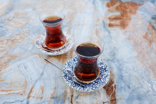 Authentic Turkish tea glasses on decorative marble surface, capturing Istanbul's cultural essence.