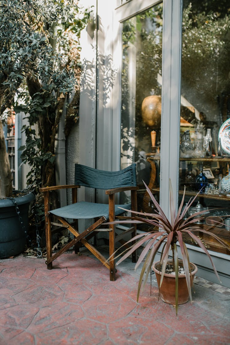 A Wooden Director's Chair Outside A Store 