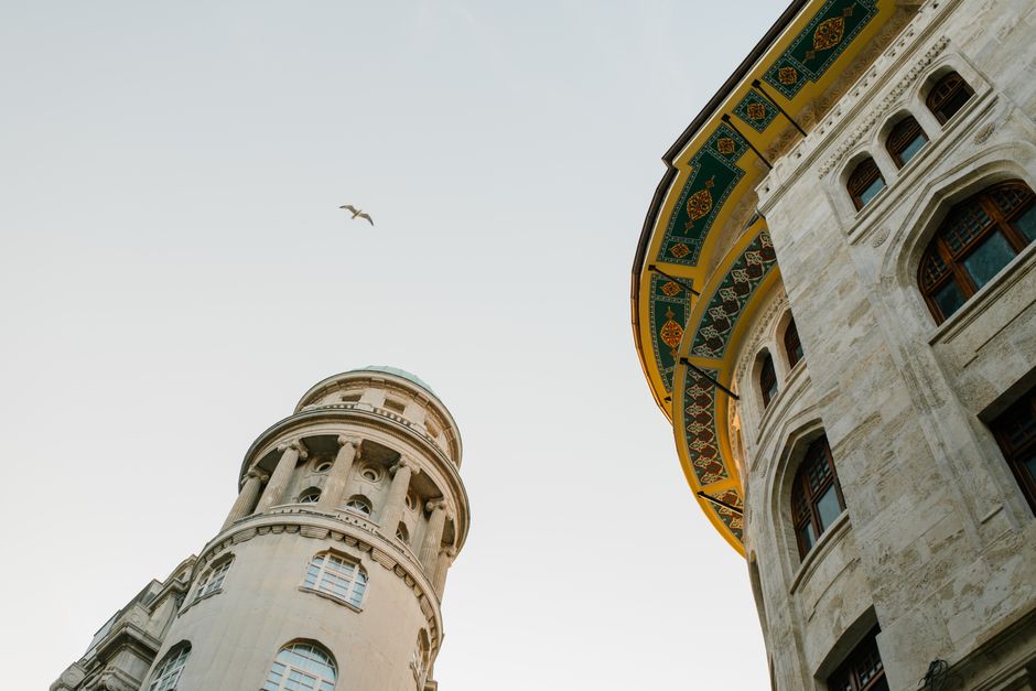 Low angle view of historic buildings and ornate facade in Istanbul, showcasing architectural beauty.