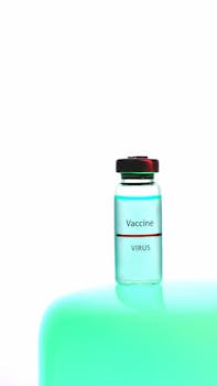 Close-up of a vaccine vial placed against a bright white background.