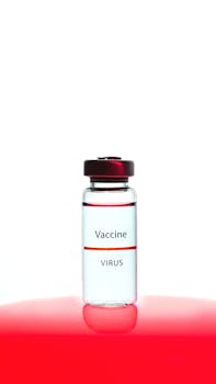 Close-up of a vaccine vial labeled 'Vaccine Virus' against a red background.