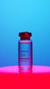 A Close-Up View of a Covid-19 Vaccine Vial on Blue Background