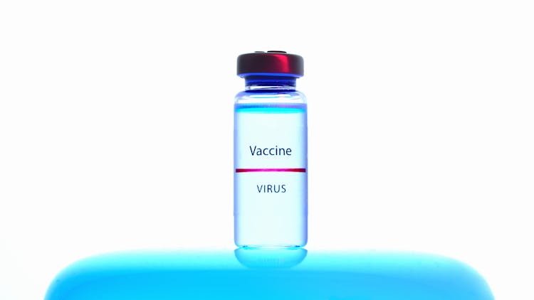 A Close-Up View Of A Vaccine Vial On White Background