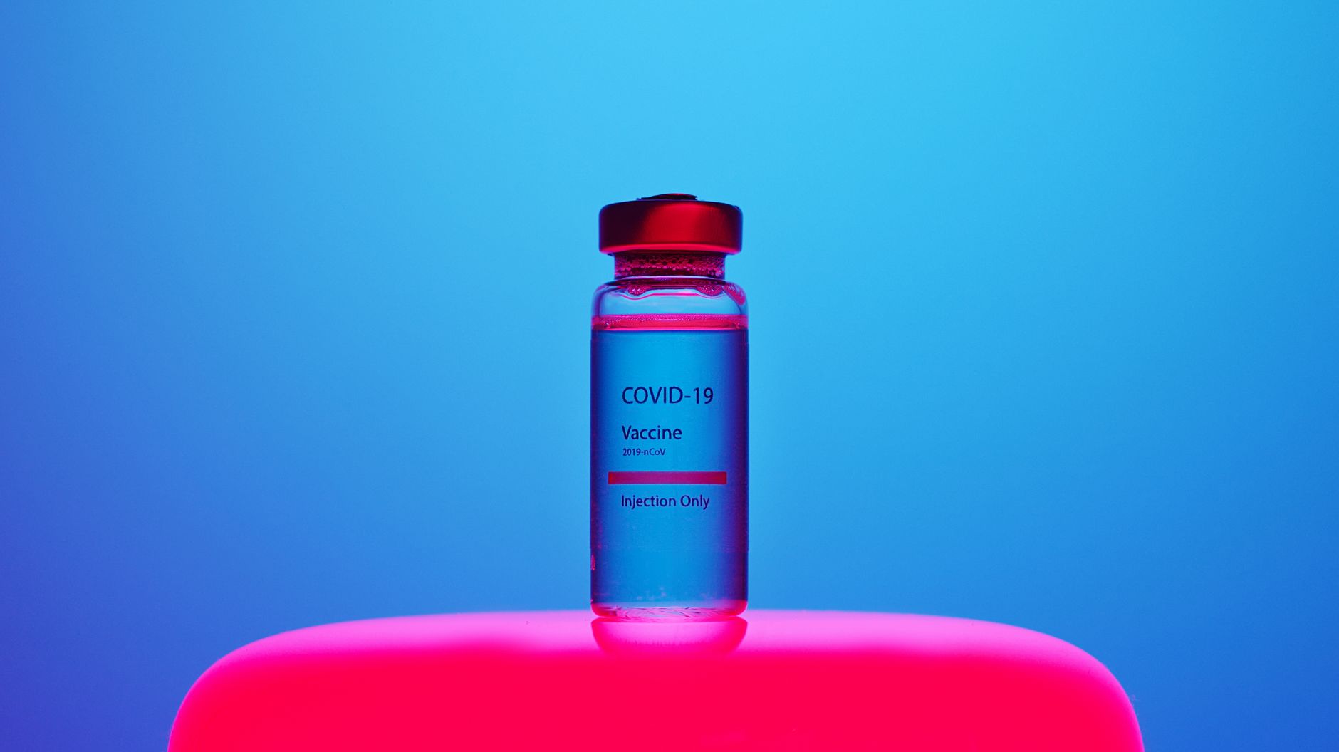 A Covid-19 Vaccine Vial on Blue Background