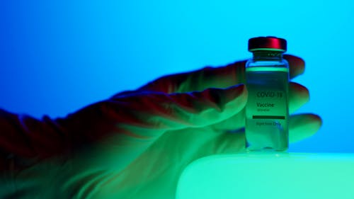 Close-Up View of a Person Holding a Vaccine Vial