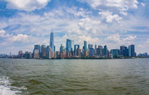 Free Scenic panorama of New York City skyline with skyscrapers and vibrant blue sky. Stock Photo