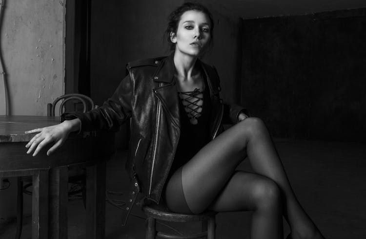 Trendy Feminine Model In Nylon Tights On Chair