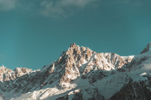 Scenic view of the snowcapped peaks of the French Alps with a vivid blue sky backdrop.