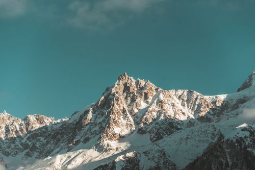 Free Scenic view of the snowcapped peaks of the French Alps with a vivid blue sky backdrop. Stock Photo